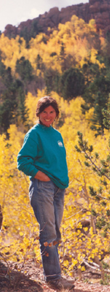 pam furumo in front yellow aspen grove in the rocky mountains